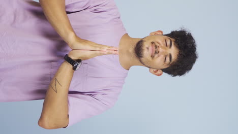 Vertical-video-of-Man-meditating-looking-at-camera.